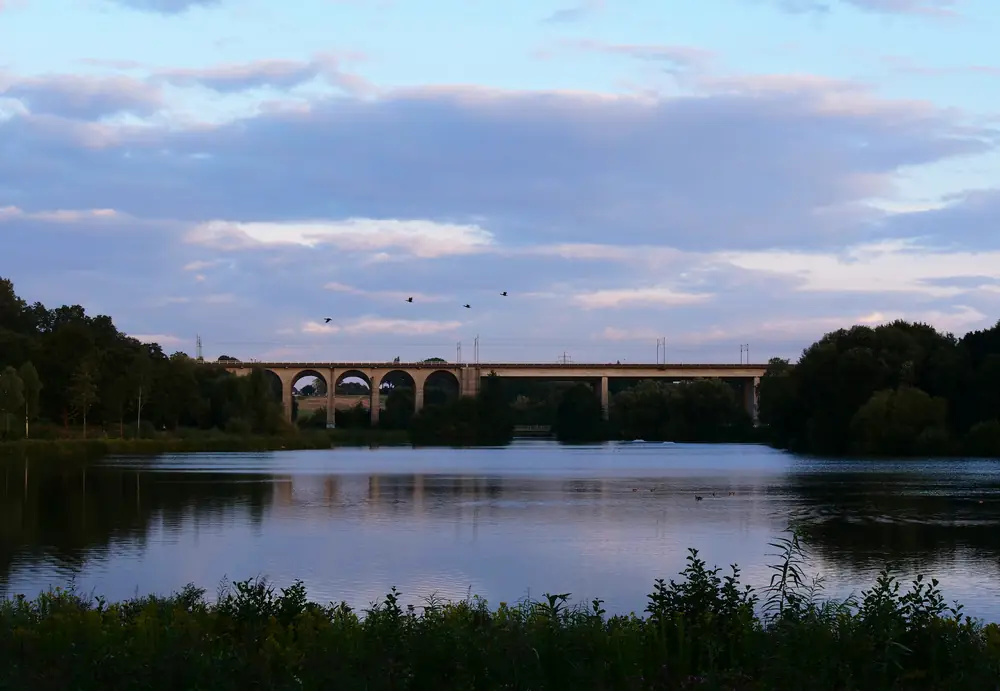 The railway viaduct over the Obersee lake at dusk